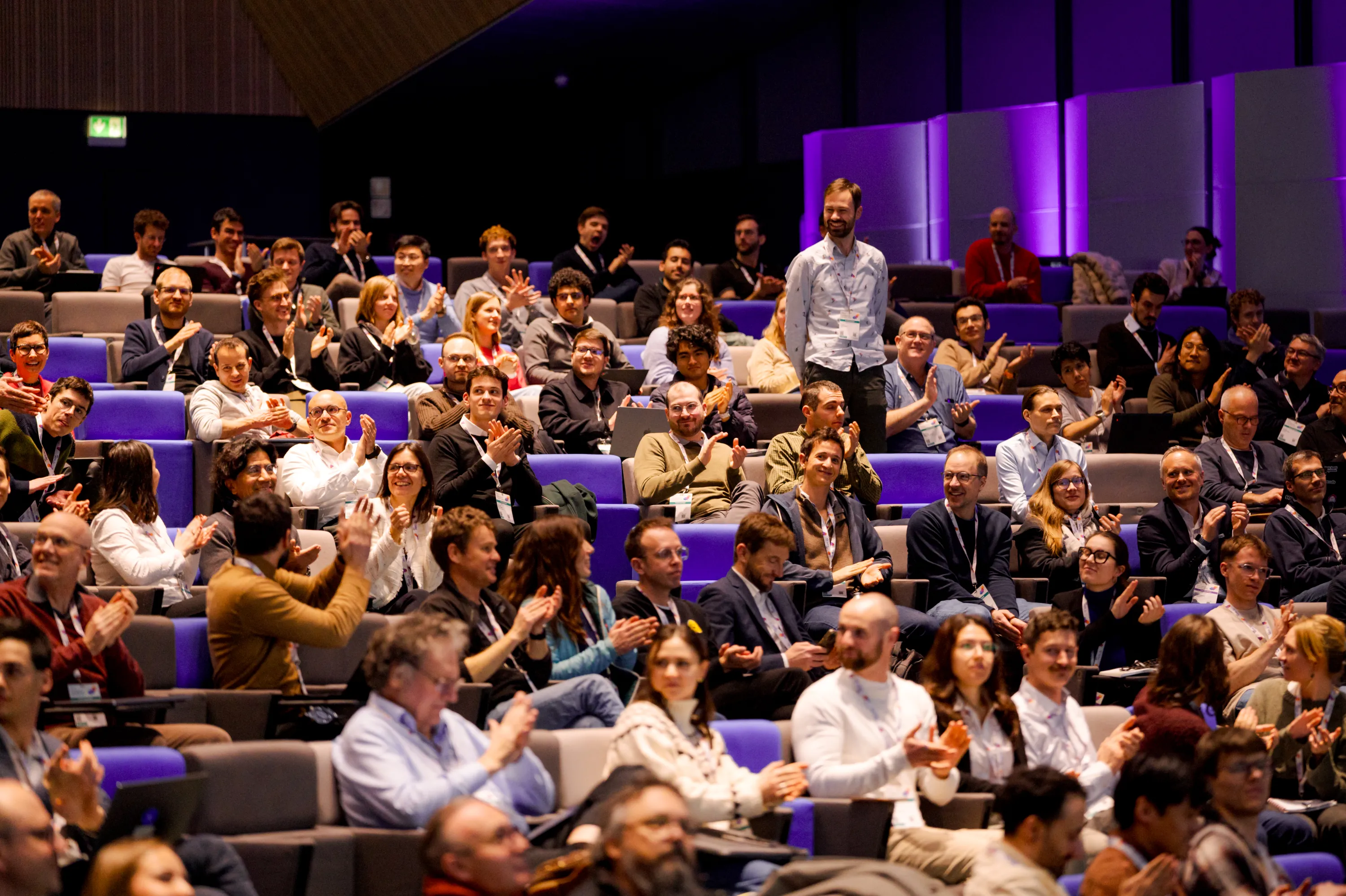 Audience applauding in a filled auditorium