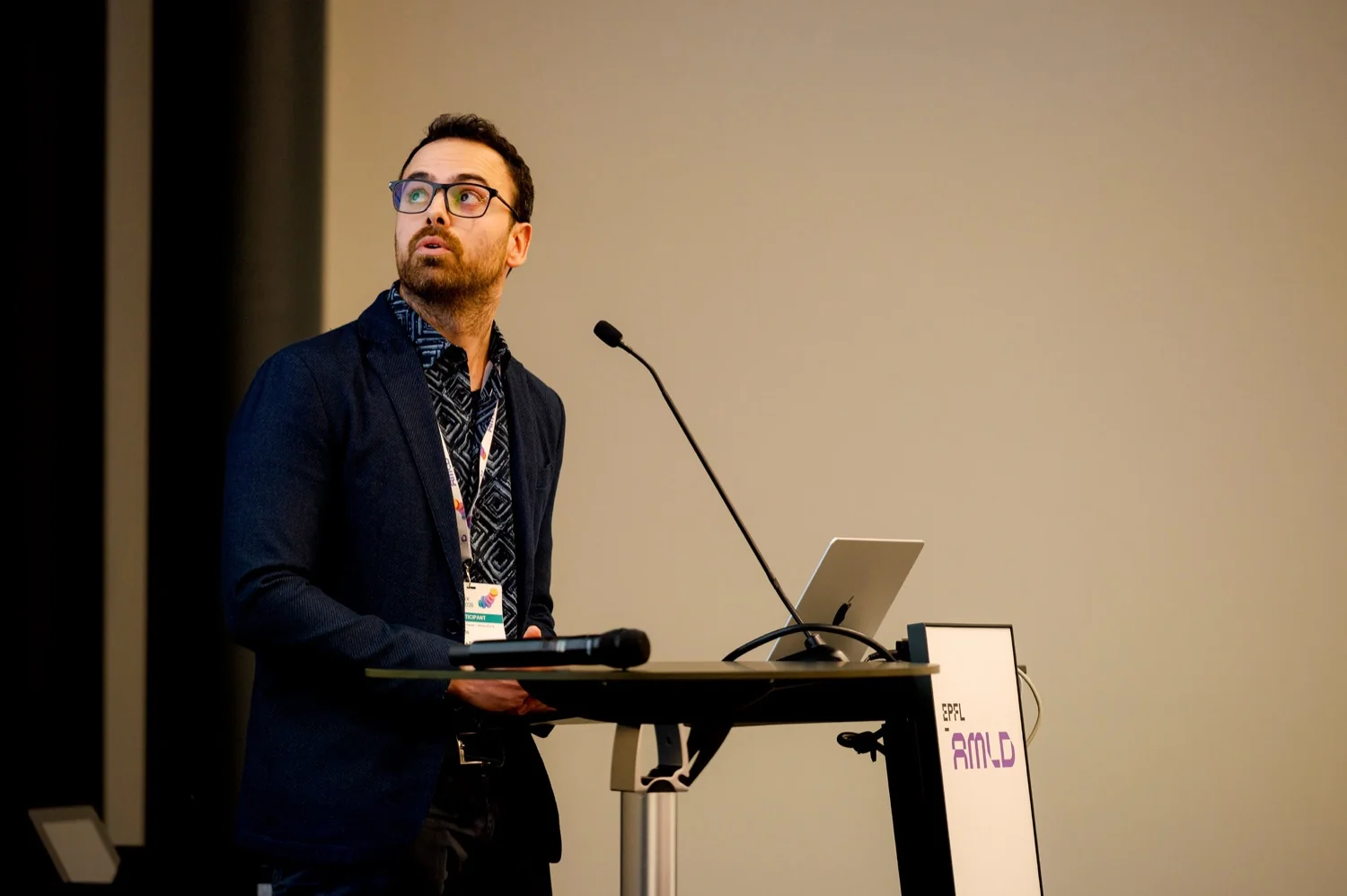 Speaker presenting during a themed track session at AMLD